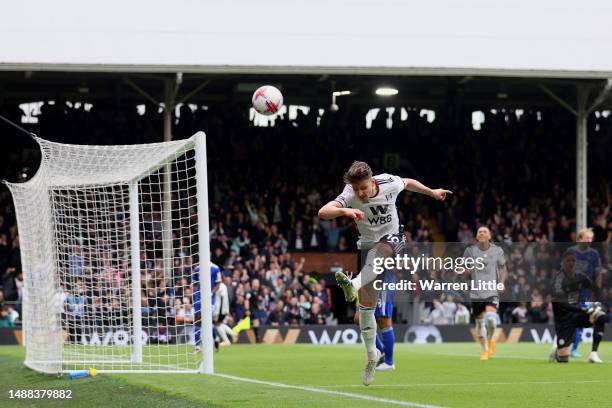 Tom Cairney of Fulham celebrates after scoring the team's fourth goal as Daniel Iversen of Leicester City reacts during the Premier League match...