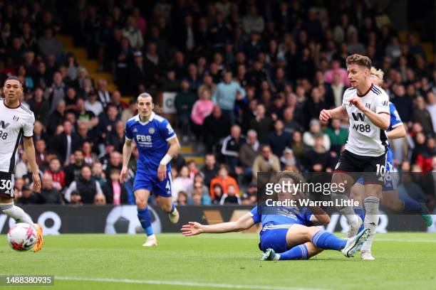 Tom Cairney of Fulham scores the team's fourth goal whilst under pressure from Wout Faes of Leicester City during the Premier League match between...