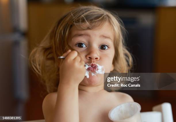 girl eating a yogurt - baby happy cute smiling baby only stock pictures, royalty-free photos & images