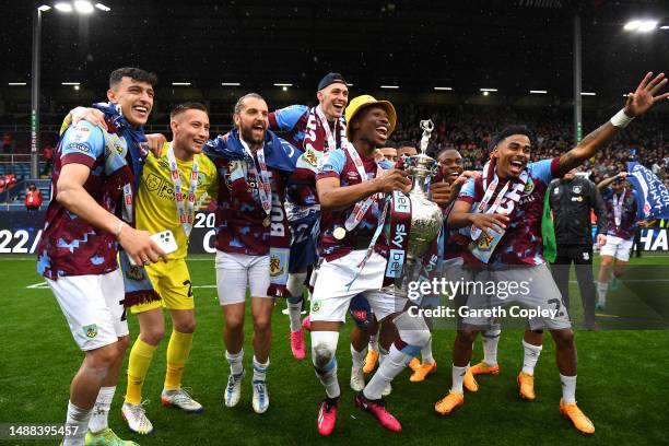 Nathan Tella of Burnley celebrates with the Sky Bet Championship trophy as players of Burnley celebrate promotion to the Premier League after...