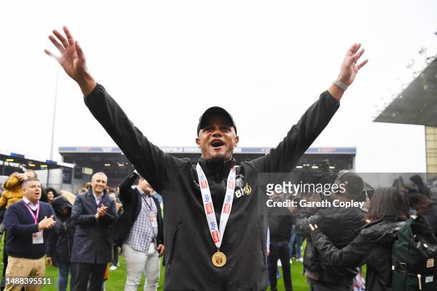 Vincent Kompany, Manager of Burnley, celebrates in front of their fans as players of Burnley celebrate promotion to the Premier League after...