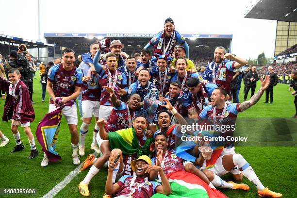 Players of Burnley celebrate with the Sky Bet Championship trophy as they celebrate promotion to the Premier League after defeating Cardiff City...