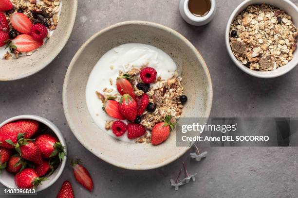 breakfast bowl with yogurt muesli strawberries and kiwis - berry stock pictures, royalty-free photos & images