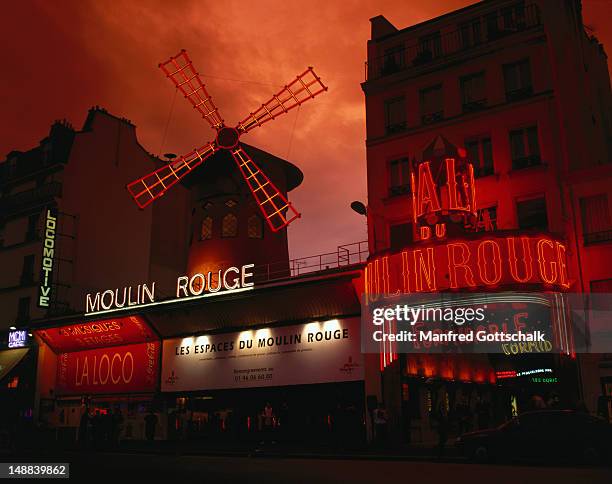 moulin rouge nightclub in the pigalle district, founded in 1889, known for its scantily clad chorus girls. - the place pigalle in paris stock pictures, royalty-free photos & images