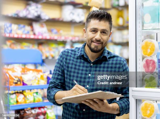 small business owner working at a local food shop - cornershop stock pictures, royalty-free photos & images