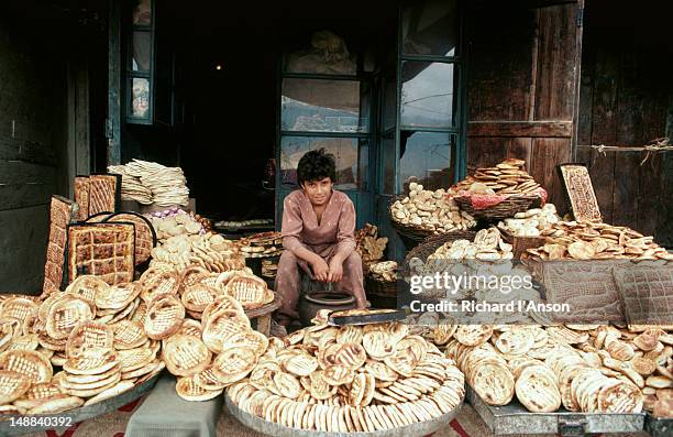 young girl at bread shop. - kashmir day stock-fotos und bilder