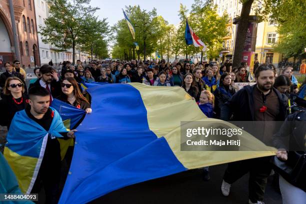 People attend a march of mourning organised by Ukrainian activists to commemorate the millions of Ukrainians who died during World War II on VE Day...