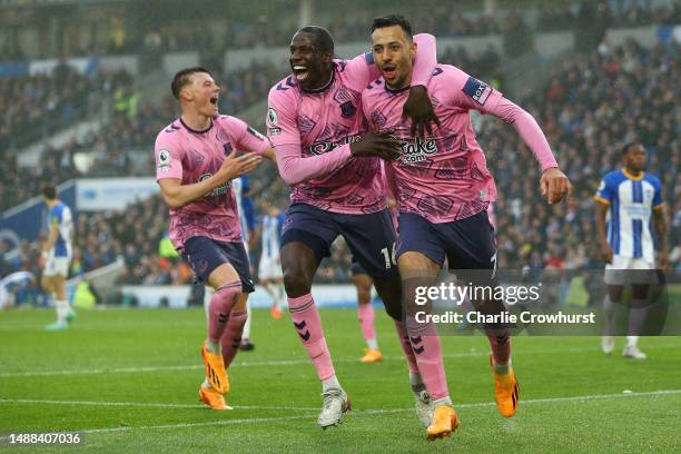 Dwight McNeil of Everton celebrates with teammate Abdoulaye Doucoure after scoring the team's fourth goal during the Premier League match between...