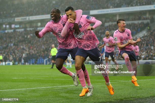 Dwight McNeil of Everton celebrates with teammate Abdoulaye Doucoure after scoring the team's fourth goal during the Premier League match between...