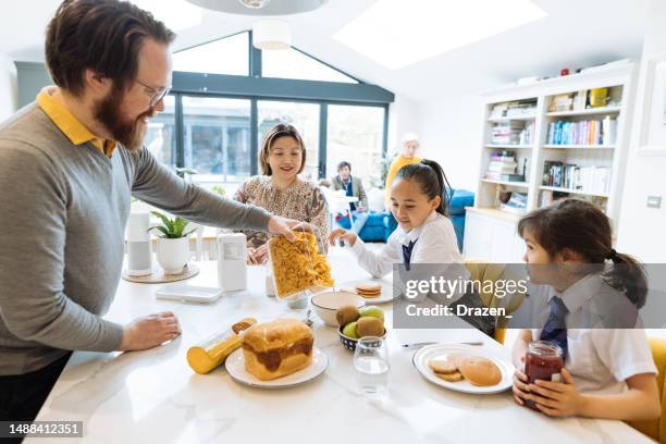 british asian family at home - family eating stock pictures, royalty-free photos & images