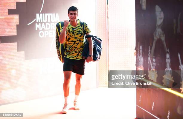 Carlos Alcaraz of Spain celebrates as he walks down the players tunnel back to the locker room after his straight sets victory against Alexander...