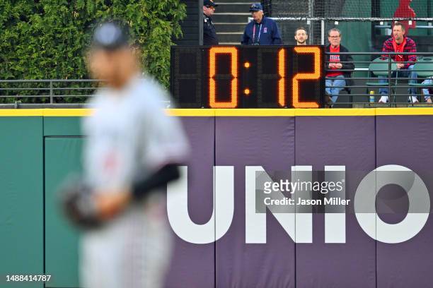 The pitch clock looms behind starting pitcher Bailey Ober of the Minnesota Twins during the first inning against the Cleveland Guardians at...
