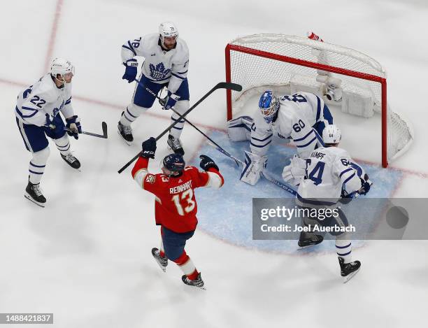 Sam Reinhart of the Florida Panthers raises his stick after scoring the overtime game winning goal past goaltender Joseph Woll the Toronto Maple...