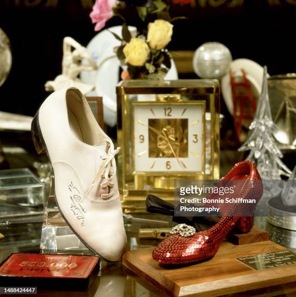 General view of actor Sammy Davis Jr. Table with a shoe signed by Fred Astaire and a shoe worn by Judy Garland in Los Angeles, California, circa 1991.