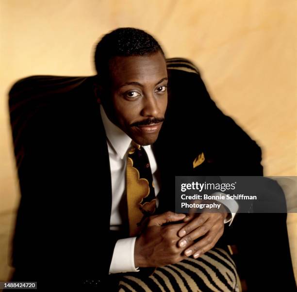 American comedian and talk show host Arsenio Hall poses for a portrait sitting in his chair in Los Angeles, California, circa 1991.