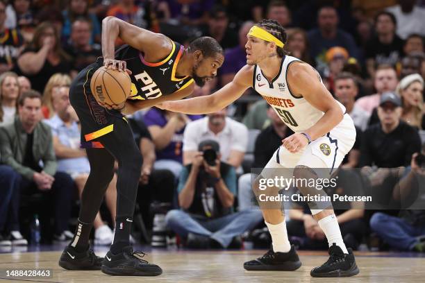 Kevin Durant of the Phoenix Suns handles the ball against Aaron Gordon of the Denver Nuggets during the first half of Game Four of the NBA Western...