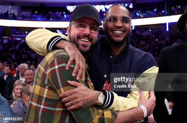 Former New York Knicks player Carmelo Anthony celebrates with Jon Chetrit after game two of the Eastern Conference Semifinals between the New York...