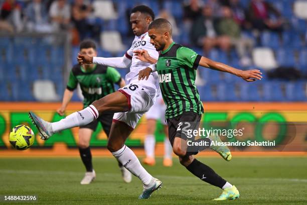 Jhon Lucumi of Bologna FC controls the ball whilst under pressure from Jeremy Toljan of US Sassuolo during the Serie A match between US Sassuolo and...