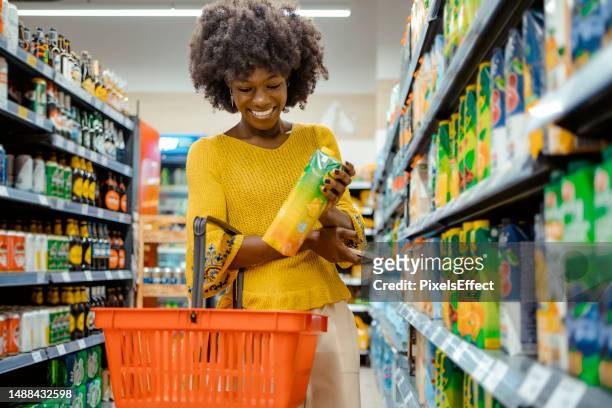 woman with food basket at grocery store - shopping basket bildbanksfoton och bilder
