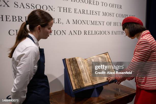 Sharon Mintz , Sotheby's senior Judaica specialist for books and manuscripts, looks through the Codex Sassoon during a press preview of at Sotheby's...