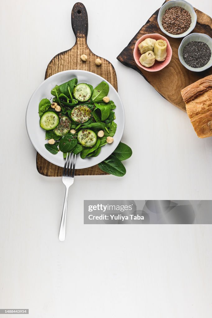 Vegetable salad in a plate on a white table.