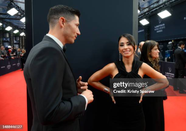 Robert Lewandowski speaks with Antonella Roccuzzo as they arrive at the 2023 Laureus World Sport Awards Paris red carpet arrivals at Cour Vendome on...