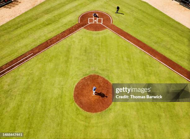 wide shot aerial view pitcher warming up on mound before baseball game - championship day three stock pictures, royalty-free photos & images