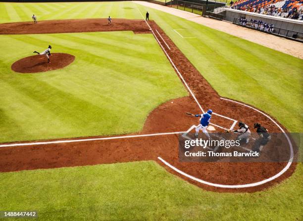 wide shot batter hitting pitch during professional baseball game - baseball game stadium stockfoto's en -beelden