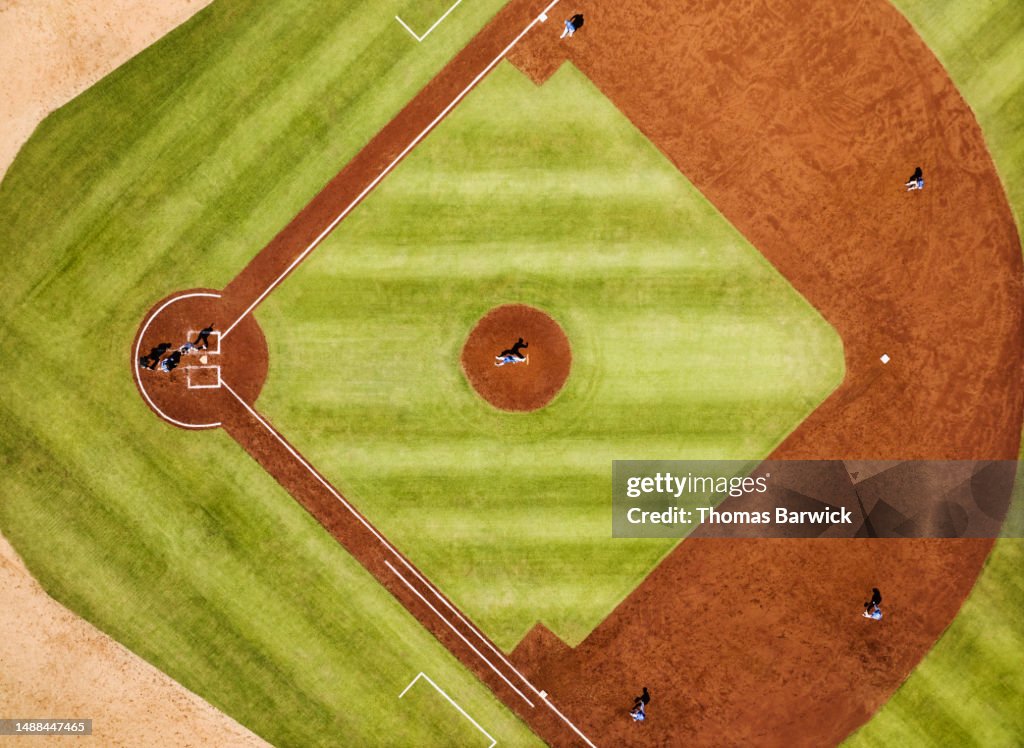 Wide shot pitcher throwing to batter during professional baseball game