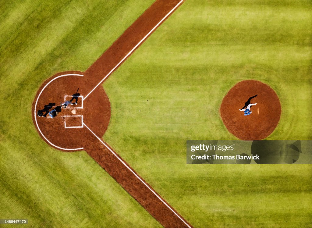 Wide shot pitcher throwing to batter during professional baseball game