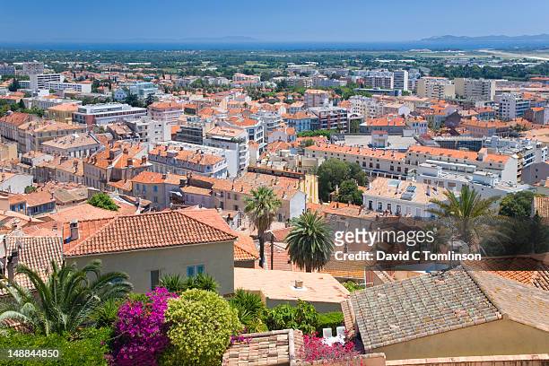 rooftops, mediterranean sea and offshore islands of levant, port-cros and porquerolles from parc castel ste-claire. - porquerolles island stock pictures, royalty-free photos & images