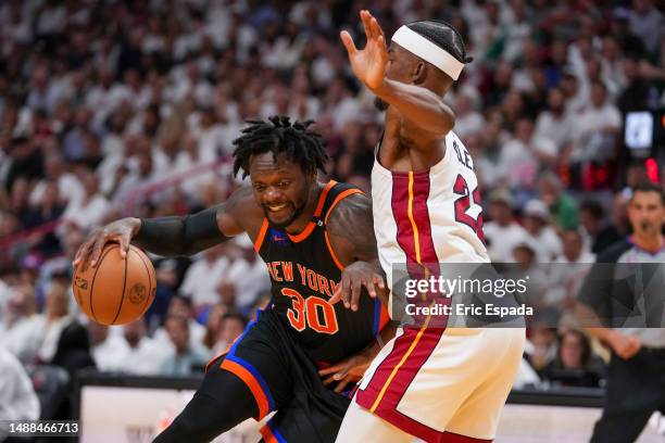 Julius Randle of the New York Knicks drives against Jimmy Butler of the Miami Heat during game four of the Eastern Conference Semifinals at Kaseya...