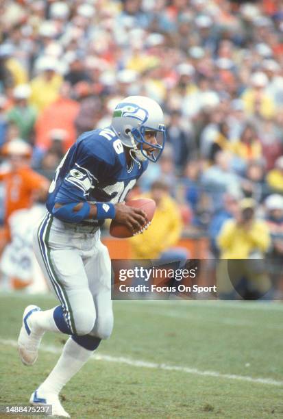 Curt Warner of the Seattle Seahawks runs the ball against the Miami Dolphins during an NFL AFC Divisional playoff football game on December 31, 1983...