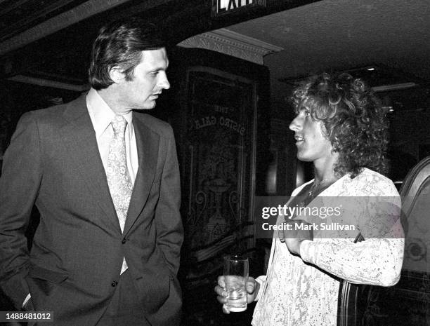 Actor Alan Alda and Singer Roger Daltrey attend a party at the Bistro restaurant in Beverly Hills, California, on August 11, 1975.