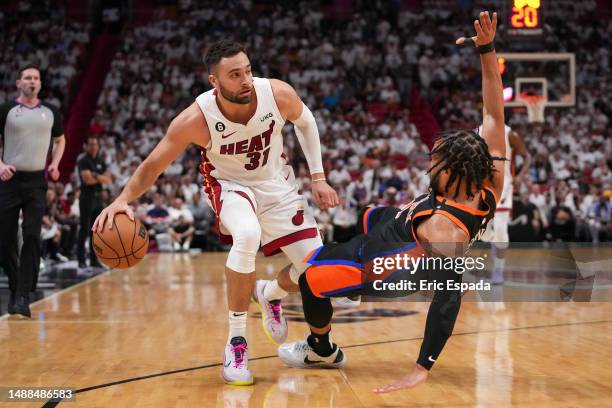 Max Strus of the Miami Heat fouls Jalen Brunson of the New York Knicks during Game Four of the Eastern Conference Semifinals at Kaseya Center on May...