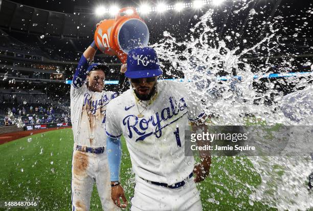 Melendez of the Kansas City Royals is doused with water by Bobby Witt Jr. #7 after the Royals defeated the Chicago White Sox 12-5- to win the game at...