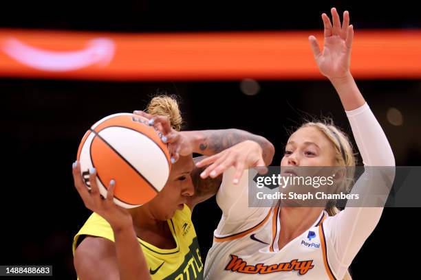 Mercedes Russell of the Seattle Storm is pressured by Sophie Cunningham of the Phoenix Mercury during the first quarter in a WNBA preseason game at...