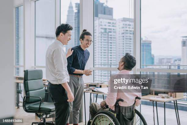 asian chinese manager introducing new comer to his colleague in wheelchair in office - day 1 stock pictures, royalty-free photos & images
