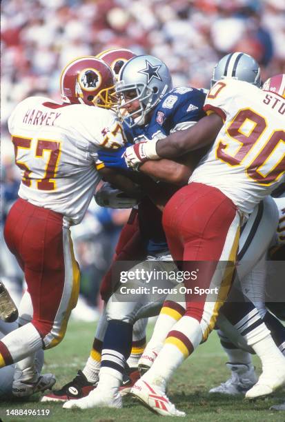 Ken Harvey of the Washington Redskins makes a stop against the Dallas Cowboys during an NFL football game October 2, 1994 at RFK Stadium in...