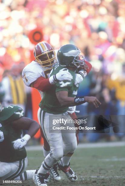 Ken Harvey of the Washington Redskins takes down Rodney Peete of the Philadelphia Eagles during an NFL football game November 26, 1995 at RFK Stadium...