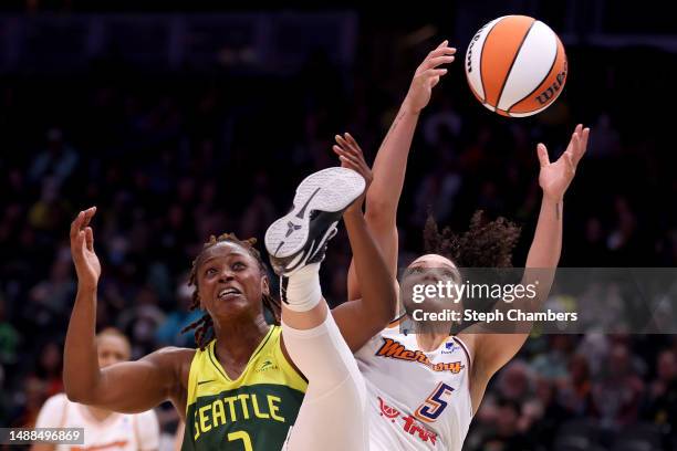 Madi Williams of the Seattle Storm and Destiny Slocum of the Phoenix Mercury reach for a rebound during the fourth quarter in a WNBA preseason game...