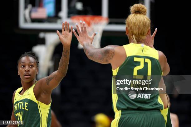 Jewell Loyd of the Seattle Storm high fives Mercedes Russell during the first quarter against the Phoenix Mercury in a WNBA preseason game at Climate...