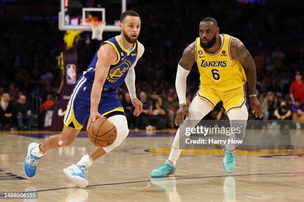 Stephen Curry of the Golden State Warriors dribbles past LeBron James of the Los Angeles Lakers during a 104-101 Lakers win in game four of the...