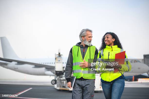 diverse airport operatives at work - airport departure board stock pictures, royalty-free photos & images