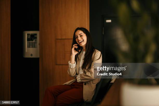 portrait of happy female hotel receptionist standing at the workplace. smiling woman receptionist working in the hotel and making a reservation. copy space - bell telephone company stock pictures, royalty-free photos & images