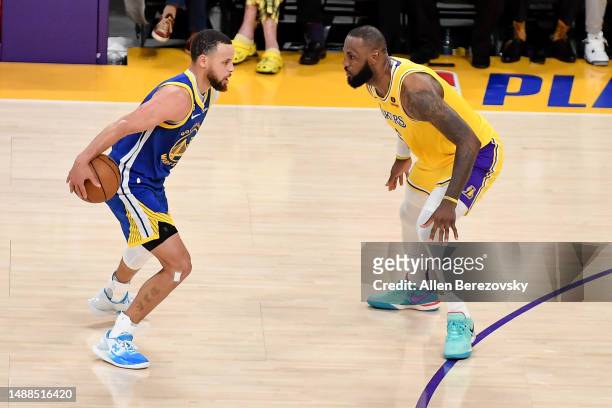 Stephen Curry of the Golden State Warriors dribbles the ball against LeBron James of the Los Angeles Lakers during Game Four of the Western...