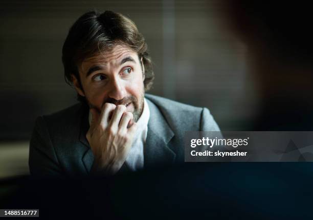 worried male entrepreneur on a meeting in the office. - nail biting stock pictures, royalty-free photos & images