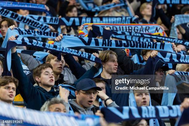 Supporters of Djurgardens IF hold up scarves during an Allsvenskan match between Djurgardens IF and Kalmar FF at Tele2 Arena on May 8, 2023 in...