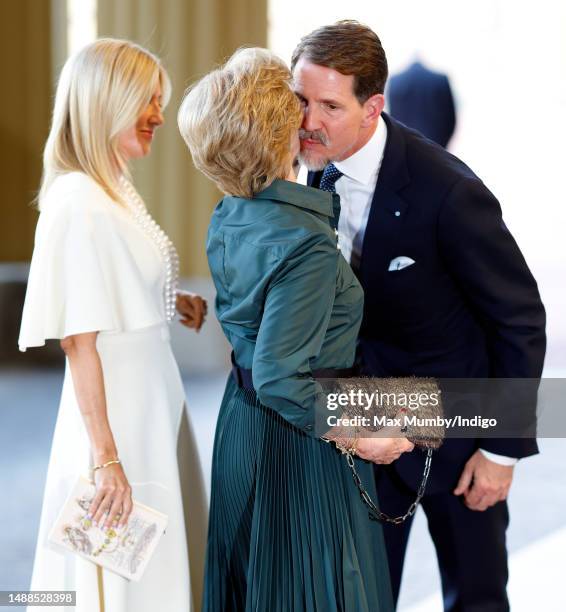 Crown Princess Marie-Chantal of Greece looks on as Crown Prince Pavlos of Greece kisses his mother Queen Anne-Marie of Greece as they attend a...