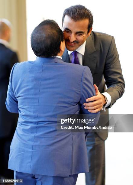 King Hamad Bin Isa Al Khalifa of Bahrain greets the Emir of Qatar, Sheikh Tamim bin Hamad Al Thani as they attend a reception at Buckingham Palace...